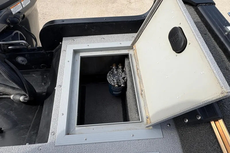 Slide: The Image of Open storage compartment on 2017 Starcraft Renegade 168 DC boat. - 24
