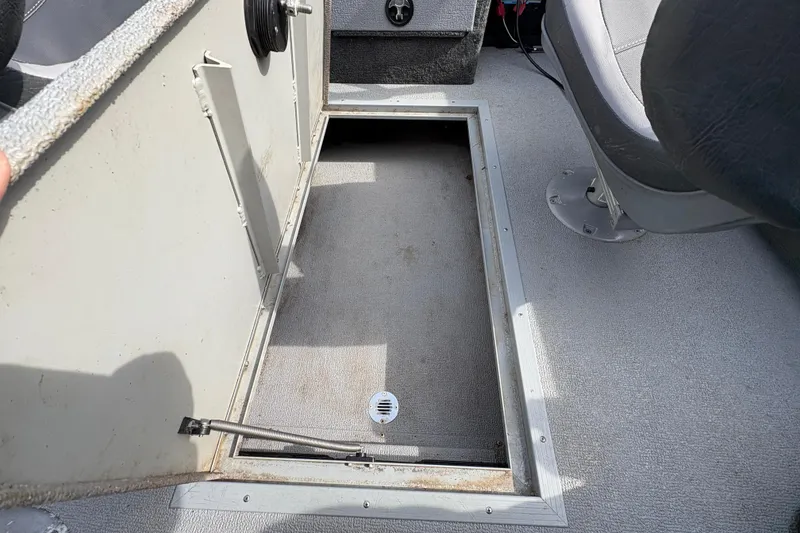Slide: The Image of Open storage compartment in 2017 Starcraft Renegade 168 DC boat interior. - 26