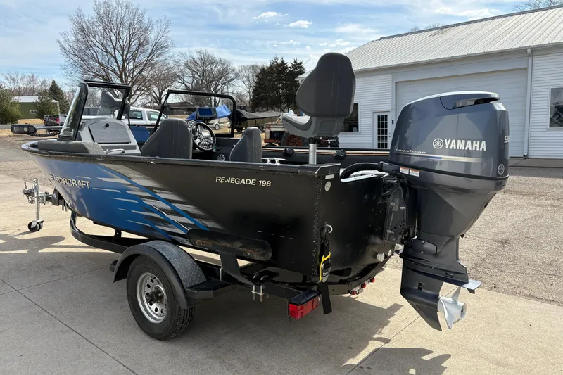 Slide: The Image of 2017 Starcraft Renegade 168 DC boat with Yamaha outboard motor, parked outdoors. - 4