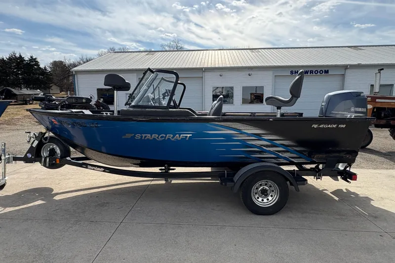 Slide: The Image of 2017 Starcraft Renegade 168 DC boat with Yamaha motor, parked outside a showroom. - 5