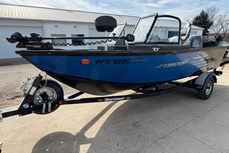 Slide: The Image of 2017 Starcraft Renegade 168 DC boat on trailer, blue exterior, parked outdoors. - 6