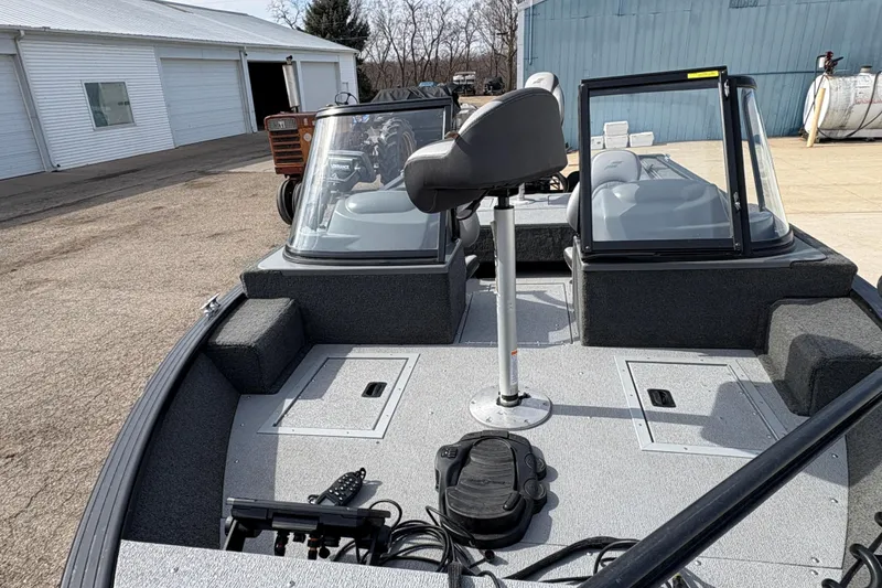 Slide: The Image of 2017 Starcraft Renegade 168 DC boat interior with seating and control panel. - 9