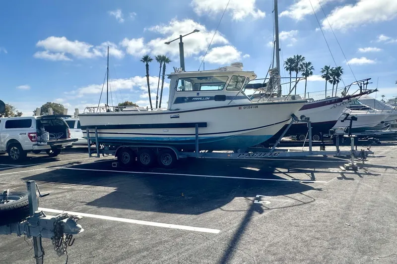 The Image of 1992 Farallon Whaleback boat on trailer in sunny marina parking lot. - 0