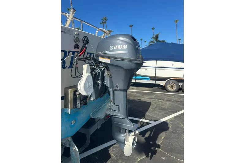 Slide: The Image of 1992 Farallon Whaleback boat with Yamaha outboard motor in parking lot. - 10