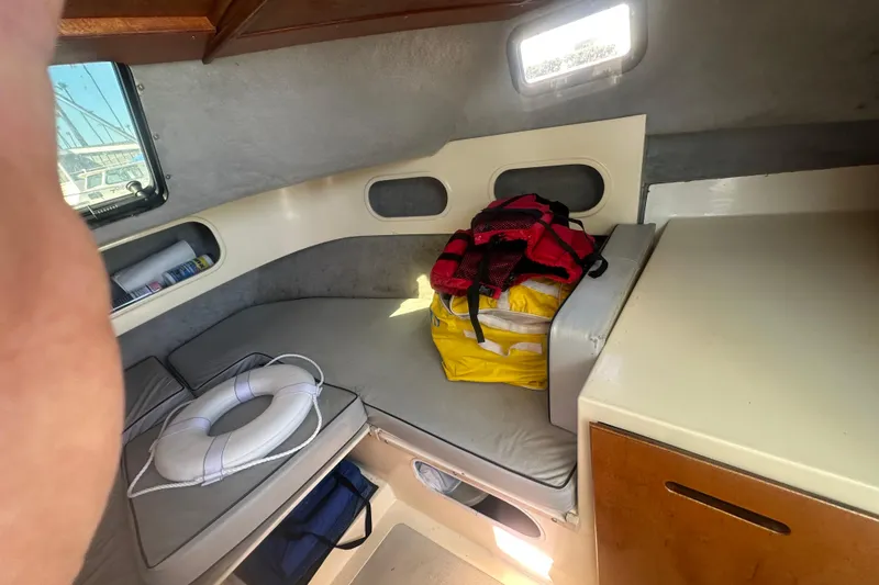 Slide: The Image of Interior of 1992 Farallon Whaleback boat with life vest and ring on cushioned seating. - 3