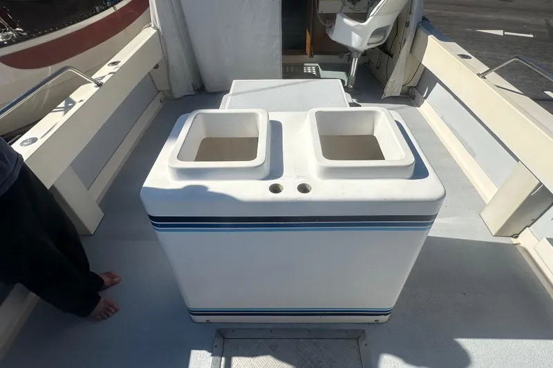 Slide: The Image of 1992 Farallon Whaleback boat interior with dual storage compartments and seating area. - 6