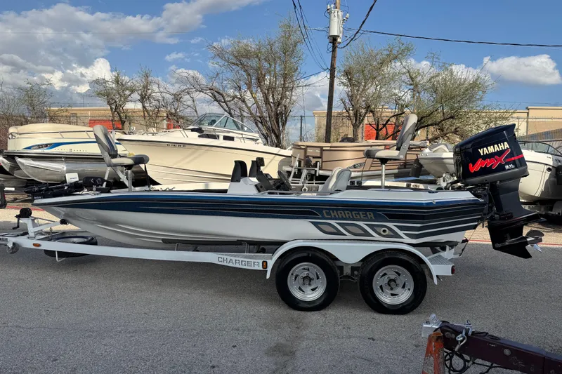Slide: The Image of 1999 Charger 195TF boat with Yamaha VMAX engine on trailer, parked outdoors. - 10