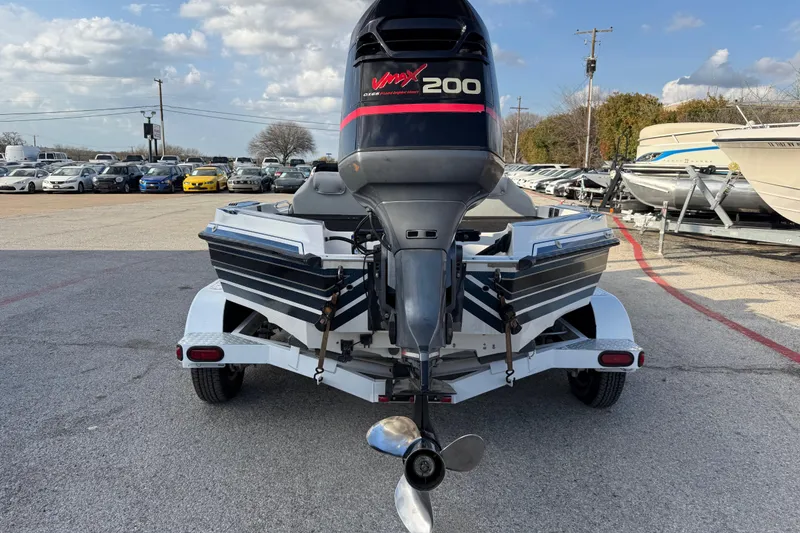 Slide: The Image of Rear view of a 1999 Charger 195TF boat with Vmax 200 outboard motor. - 13