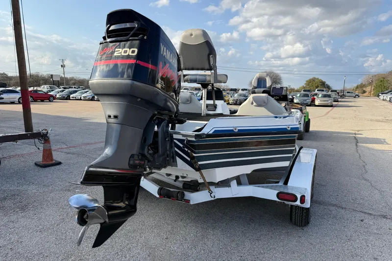 Slide: The Image of 1999 Charger 195TF boat with Yamaha VMAX 200 outboard motor in parking lot. - 14