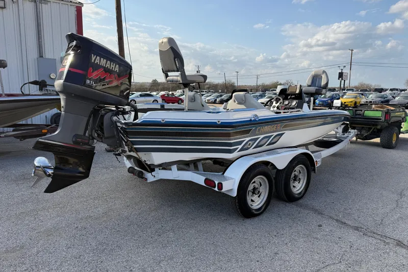 Slide: The Image of 1999 Charger 195TF boat with Yamaha VMAX engine on a trailer in a parking lot. - 15