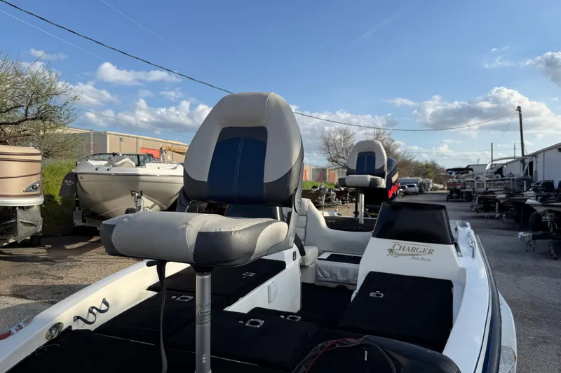 Slide: The Image of 1999 Charger 195TF boat with seating, parked outdoors under a clear sky. - 18