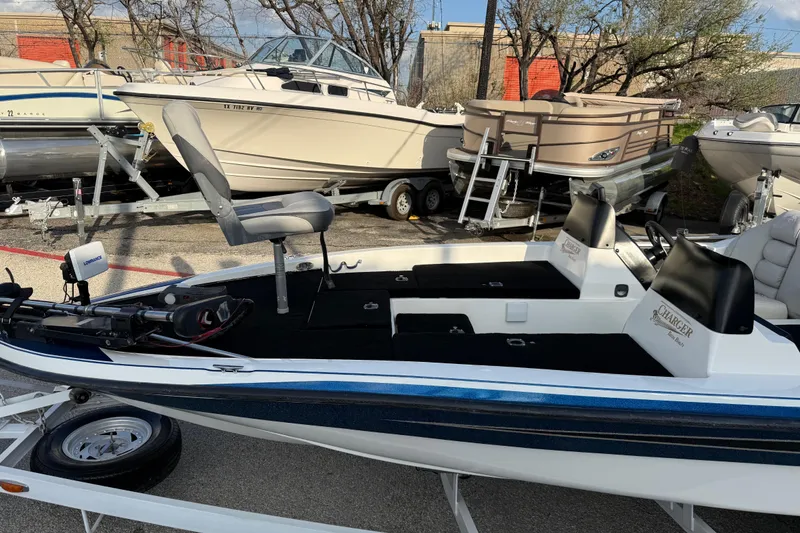 Slide: The Image of 1999 Charger 195TF boat on trailer, featuring seating and fishing equipment. - 20