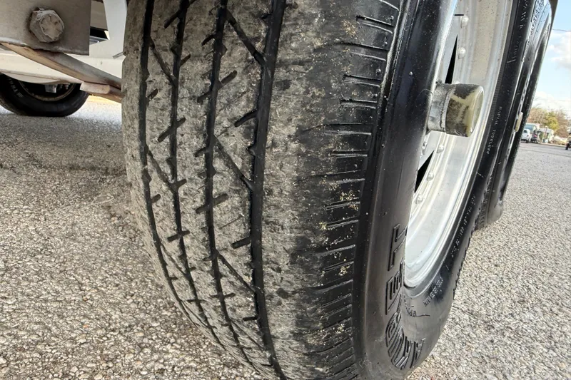 Slide: The Image of Close-up of a worn tire on a 1999 Charger 195TF vehicle. - 24
