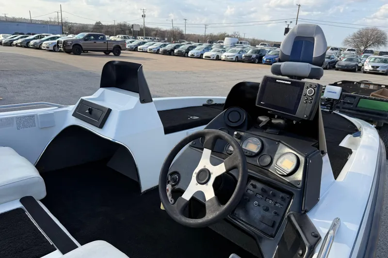 Slide: The Image of 1999 Charger 195TF boat interior with steering wheel and navigation equipment. - 29