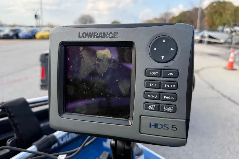 Slide: The Image of Lowrance HDS 5 fishfinder on a 1999 Charger 195TF boat, parked outdoors. - 31
