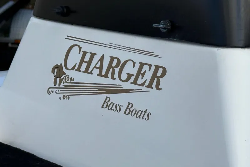 Slide: The Image of 1999 Charger 195TF Bass Boat logo on white surface. - 34