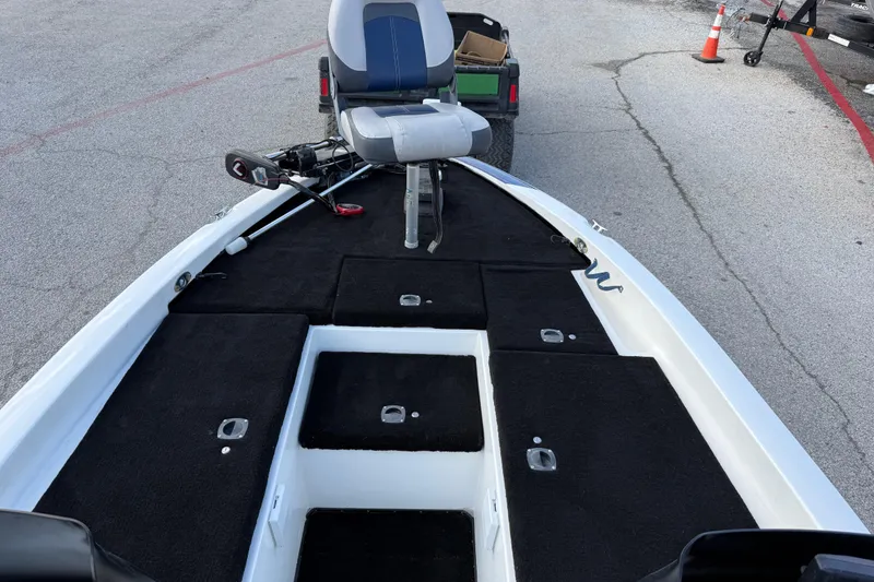 Slide: The Image of 1999 Charger 195TF boat interior with seating and storage compartments. - 35