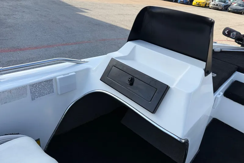 Slide: The Image of 1999 Charger 195TF boat dashboard with storage compartment, white and black design. - 46