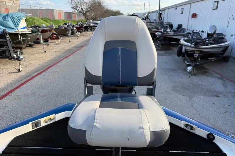 Slide: The Image of Boat seat on a 1999 Charger 195TF, surrounded by parked boats. - 49
