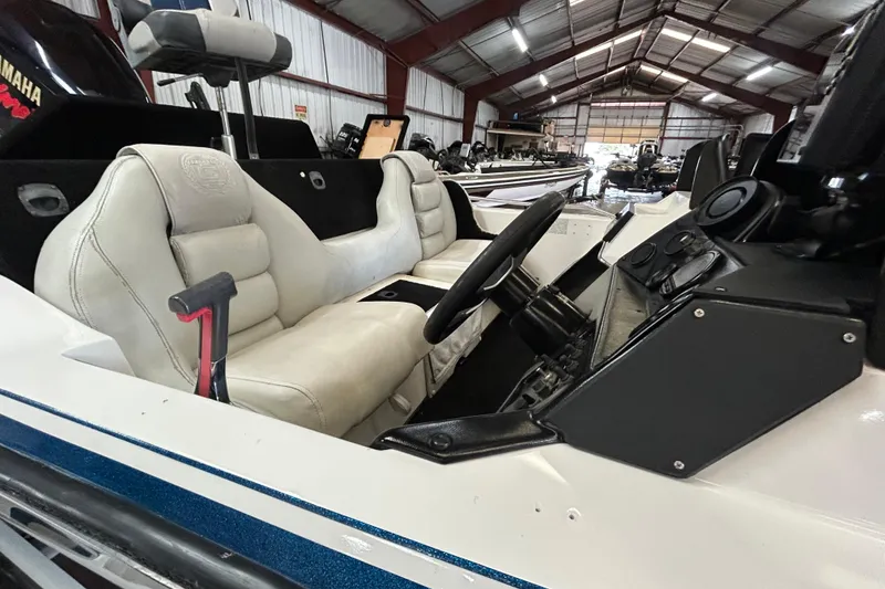 Slide: The Image of 1999 Charger 195TF boat on trailer, close-up view of hull and trailer details. - 5