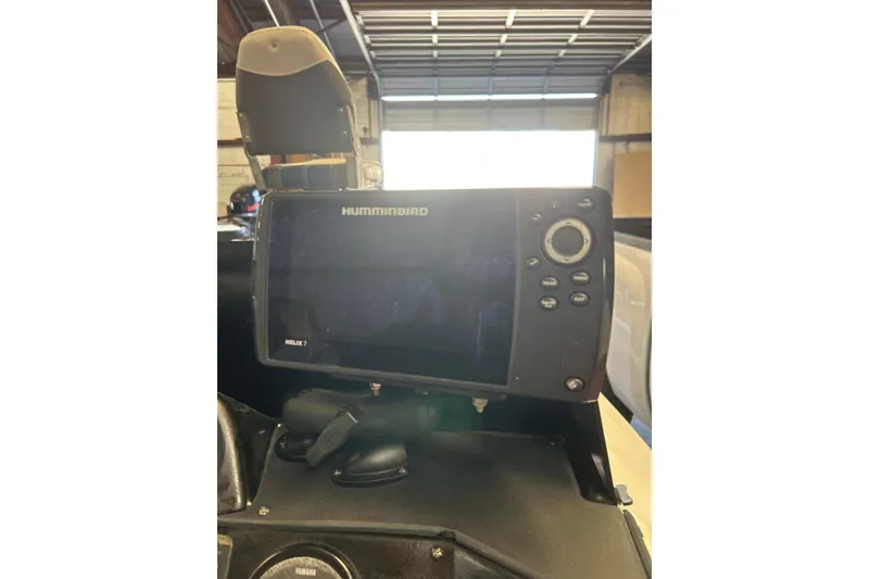 Slide: The Image of 1999 Charger 195TF boat on trailer, featuring Yamaha engine, parked outdoors. - 7