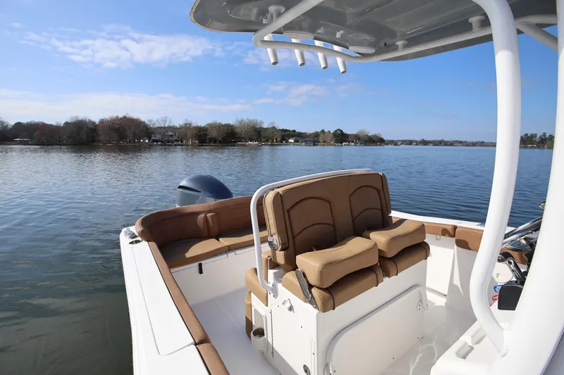 Slide: The Image of 2020 Sea Hunt Ultra 255 SE boat on calm lake with clear sky. - 11