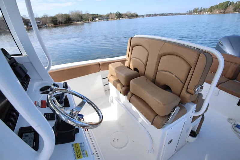 Slide: The Image of 2020 Sea Hunt Ultra 255 SE boat interior with steering wheel and seating. - 12