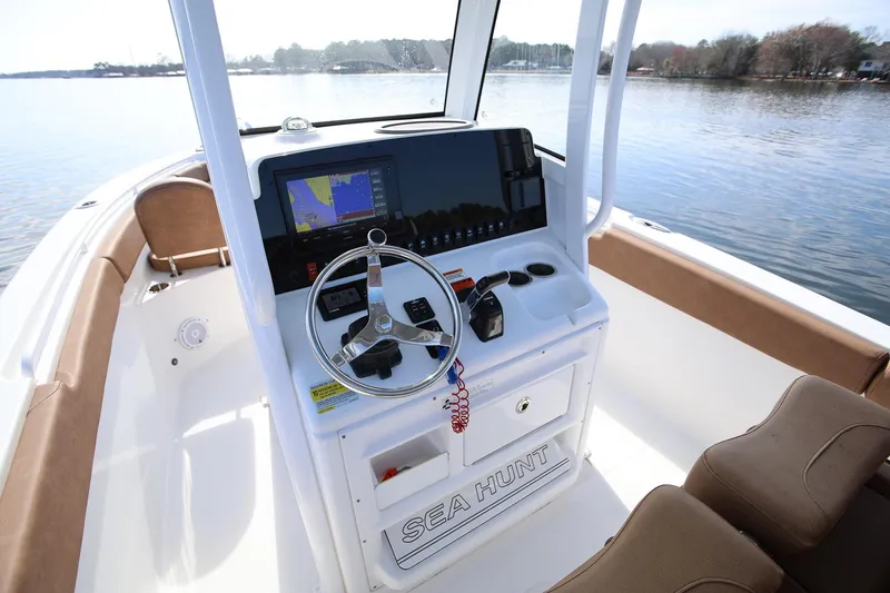 Slide: The Image of 2020 Sea Hunt Ultra 255 SE boat console with steering wheel and navigation display. - 13