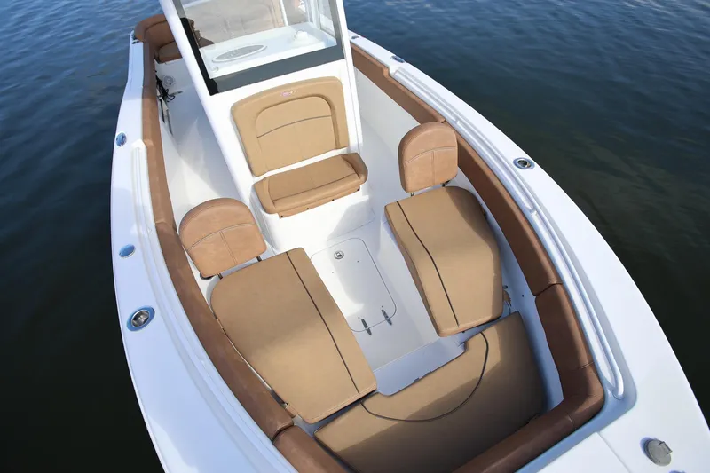 Slide: The Image of 2020 Sea Hunt Ultra 255 SE boat interior with tan seating and white deck. - 19