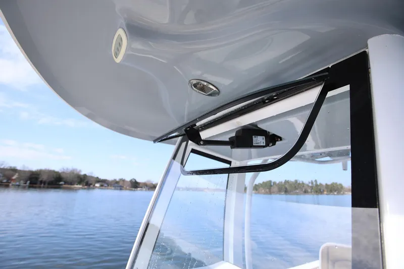 Slide: The Image of 2020 Sea Hunt Ultra 255 SE boat windshield detail with scenic lake view. - 23