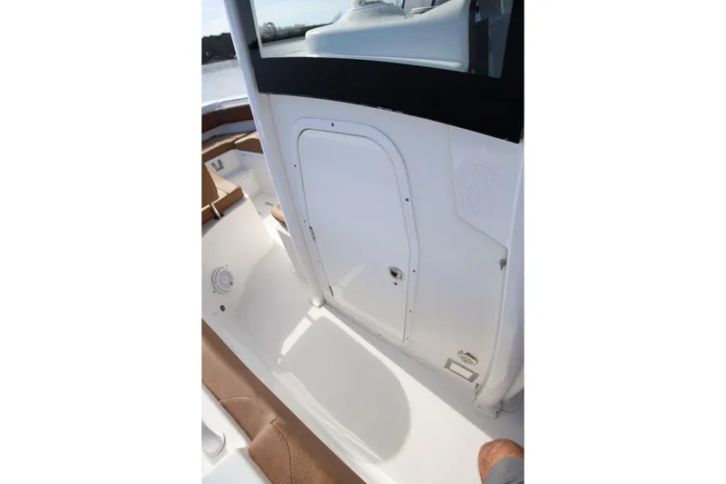 Slide: The Image of 2020 Sea Hunt Ultra 255 SE boat interior with white and brown seating. - 25