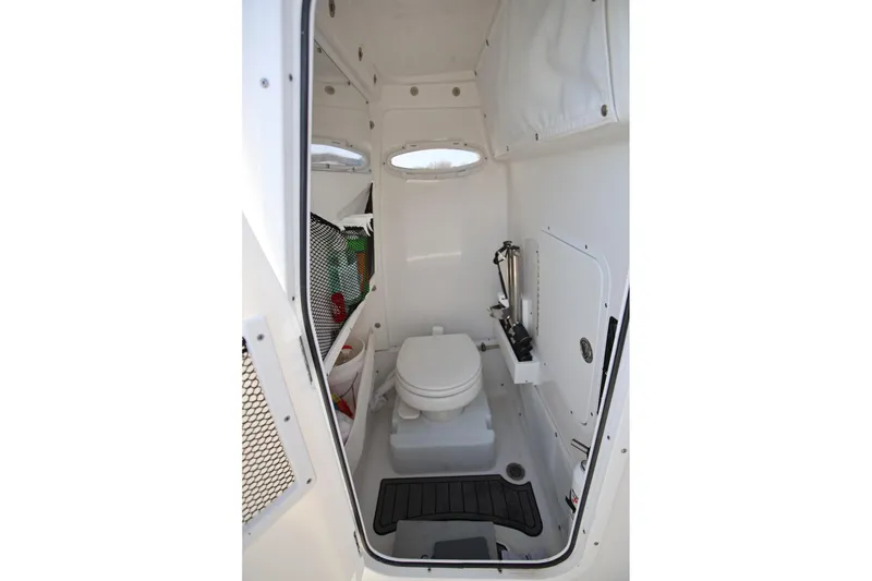 Slide: The Image of 2020 Sea Hunt Ultra 255 SE boat interior with compact marine toilet. - 27