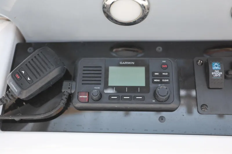 Slide: The Image of Garmin marine radio and controls on 2020 Sea Hunt Ultra 255 SE boat dashboard. - 32