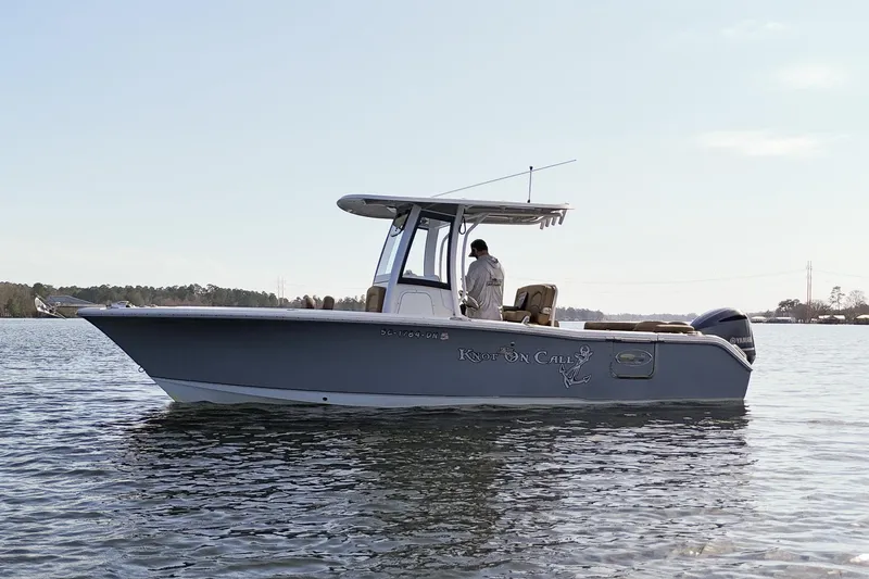 Slide: The Image of 2020 Sea Hunt Ultra 255 SE boat on calm water, side view. - 4