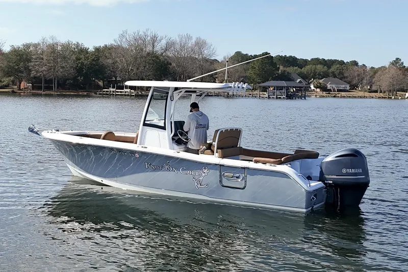 Slide: The Image of 2020 Sea Hunt Ultra 255 SE boat on calm water with Yamaha engine. - 5