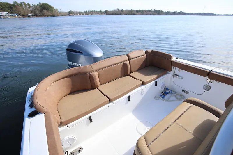 Slide: The Image of 2020 Sea Hunt Ultra 255 SE boat interior with brown seating and Yamaha engine. - 7