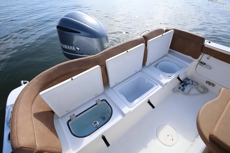 Slide: The Image of 2020 Sea Hunt Ultra 255 SE boat interior with Yamaha engine, featuring storage compartments. - 8