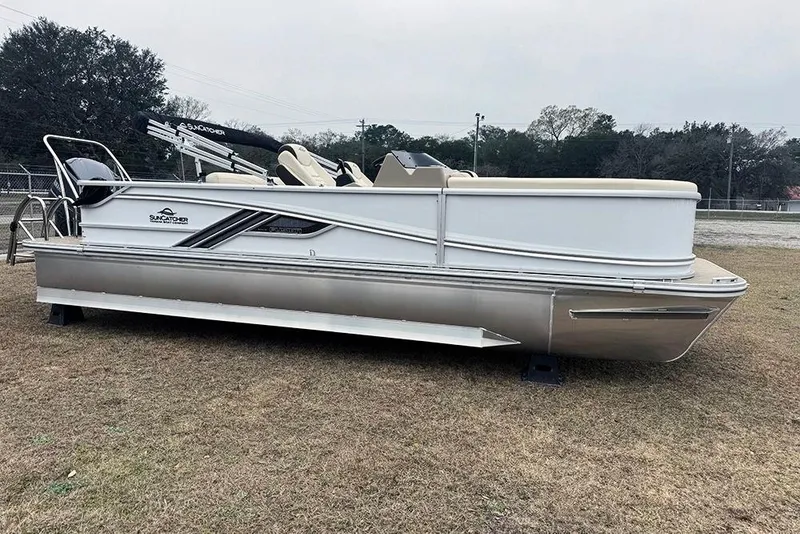 The Image of 2026 SunCatcher Fusion 324SL pontoon boat on grass, side view. - 1