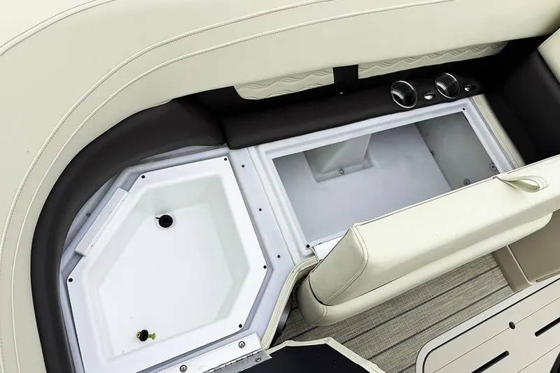 Slide: The Image of Open storage compartment in 2026 SunCatcher Fusion 324SL boat, featuring beige seating. - 13