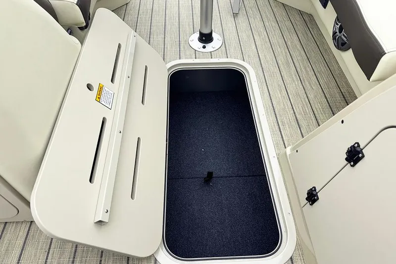 Slide: The Image of Open storage compartment on 2026 SunCatcher Fusion 324SL boat, featuring carpeted interior and sleek design. - 21