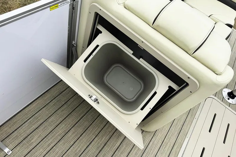 Slide: The Image of Open storage compartment on 2026 SunCatcher Fusion 324SL boat with beige seating. - 23
