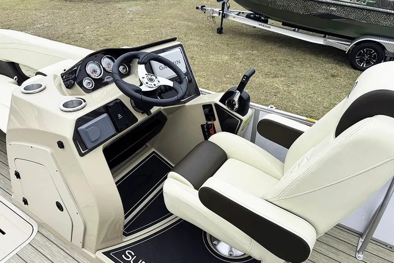 Slide: The Image of 2026 SunCatcher Fusion 324SL boat cockpit with steering wheel and control panel. - 26