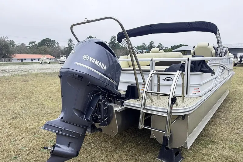 Slide: The Image of 2026 SunCatcher Fusion 324SL pontoon boat with Yamaha outboard motor, parked on grass. - 3