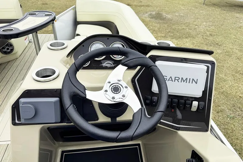 Slide: The Image of 2026 SunCatcher Fusion 324SL boat dashboard with Garmin navigation system and steering wheel. - 30