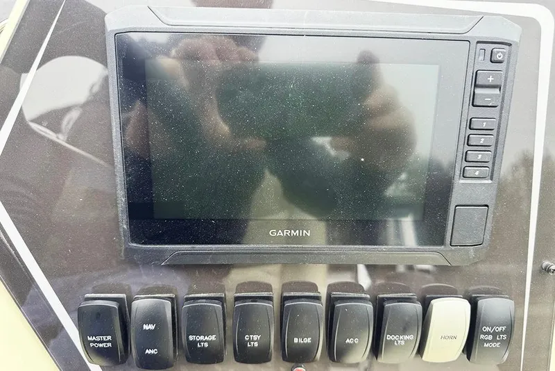 Slide: The Image of Control panel of 2026 SunCatcher Fusion 324SL with Garmin display and various switches. - 31