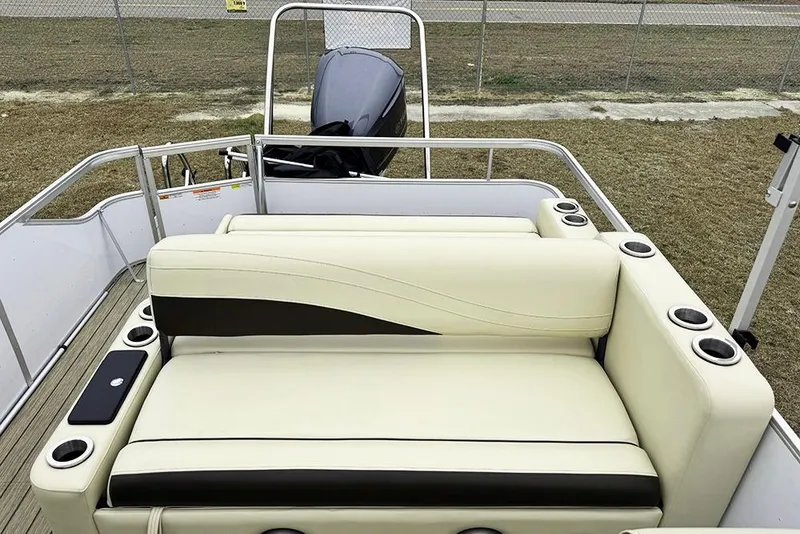 Slide: The Image of 2026 SunCatcher Fusion 324SL boat interior with beige seating and cup holders. - 32