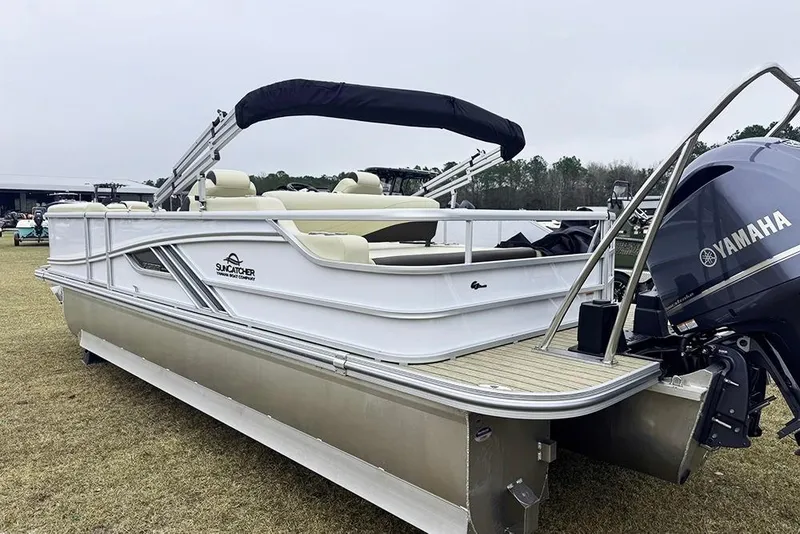 Slide: The Image of 2026 SunCatcher Fusion 324SL pontoon boat with Yamaha engine, displayed outdoors. - 5