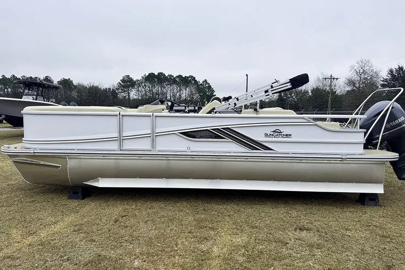 Slide: The Image of 2026 SunCatcher Fusion 324SL pontoon boat on grass, side view. - 6