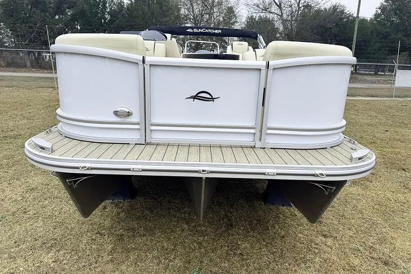 Slide: The Image of 2026 SunCatcher Fusion 324SL pontoon boat on grass, rear view. - 8