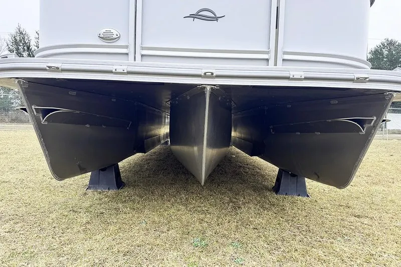 Slide: The Image of 2026 SunCatcher Fusion 324SL pontoon boat hull on grass. - 9